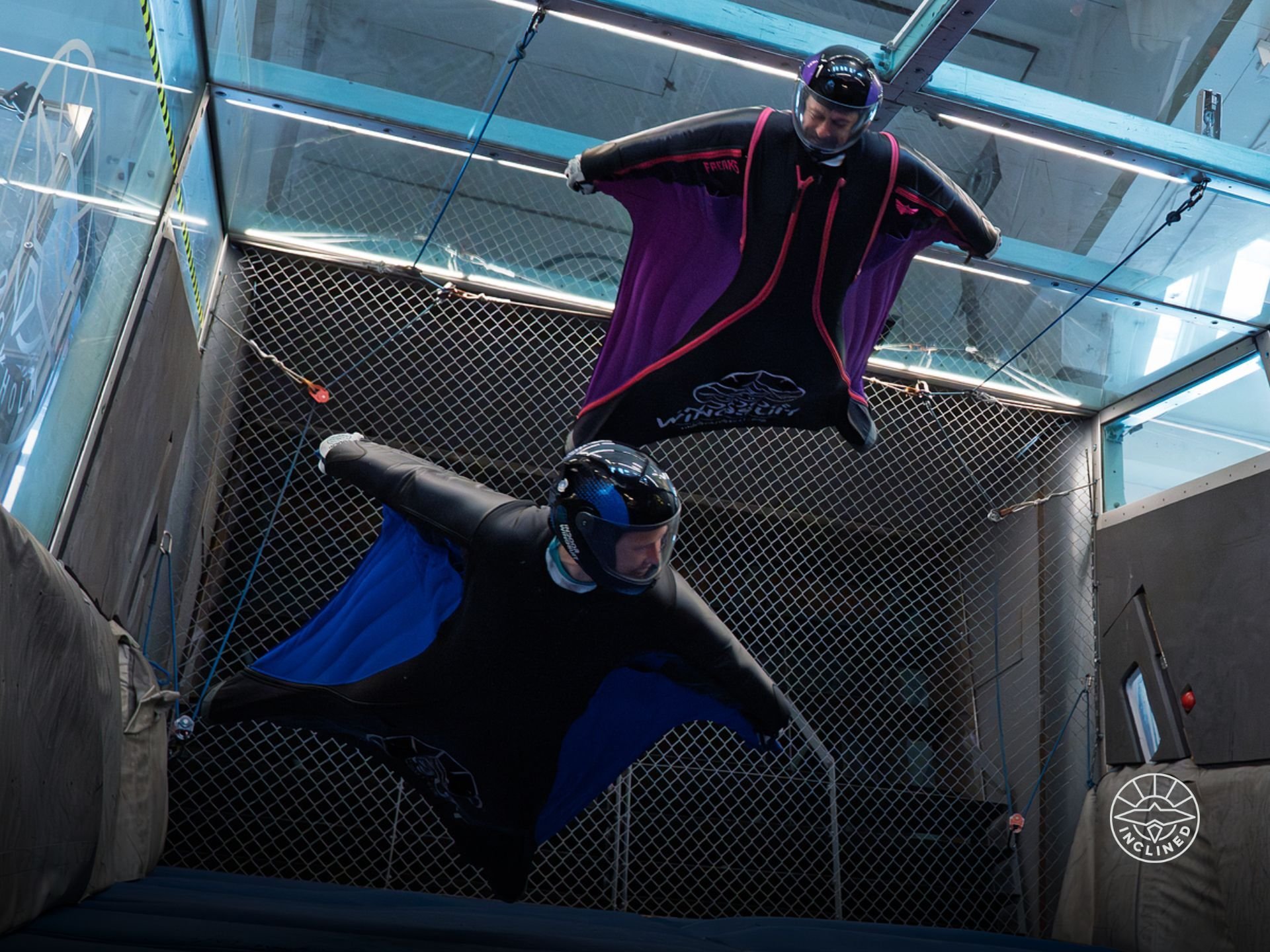Proflyer executing high-speed, precise movements during an indoor wingsuit training session.