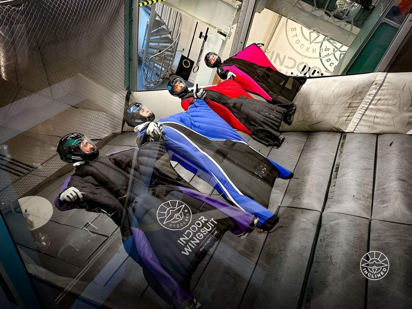 Experienced proflyer performing advanced manoeuvres inside the inclined wingsuit tunnel with strong body control.