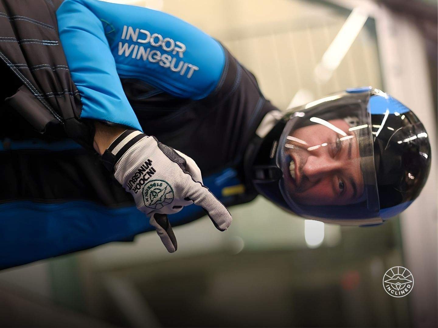 Proflyer executing high-speed, precise movements during an indoor wingsuit training session.