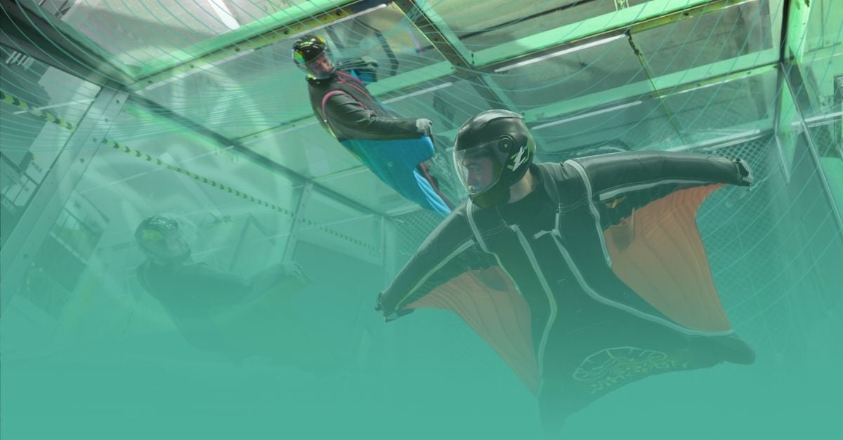 Proflyer executing high-speed, precise movements during an indoor wingsuit training session.